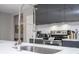 Close-up of kitchen faucet with modern cabinetry and stainless steel appliances in the background at 4414 Le Reve Ct, Kissimmee, FL 34746