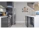 Modern kitchen featuring stainless steel appliances, grey cabinetry, and quartz countertops at 4414 Le Reve Ct, Kissimmee, FL 34746