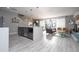 Open-concept kitchen and living area featuring modern gray cabinetry, and sleek tile flooring at 4414 Le Reve Ct, Kissimmee, FL 34746
