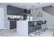 Contemporary kitchen with stainless steel appliances, an island with seating, and modern lighting at 4414 Le Reve Ct, Kissimmee, FL 34746