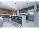 Open kitchen featuring stainless steel appliances, grey cabinetry, and a center island with seating at 4414 Le Reve Ct, Kissimmee, FL 34746