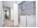 Laundry room with white washer and dryer set and wire rack shelving at 4414 Le Reve Ct, Kissimmee, FL 34746