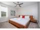 Bedroom with wooden bed frame, ceiling fan, carpeted floors, and natural lighting at 4414 Le Reve Ct, Kissimmee, FL 34746
