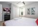 Bedroom with wooden bed frame, mounted TV, ceiling fan, and carpeted floors at 4414 Le Reve Ct, Kissimmee, FL 34746