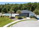 Community pool and clubhouse surrounded by lush landscaping and palm trees at 4414 Le Reve Ct, Kissimmee, FL 34746