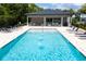 Community pool featuring fountains, lounge chairs and a covered sitting area at 4414 Le Reve Ct, Kissimmee, FL 34746