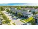 Street view of modern townhomes with lush landscaping, garages and sidewalks at 4414 Le Reve Ct, Kissimmee, FL 34746