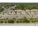Aerial view showcasing townhome community with lush landscaping, garages, and ample parking spaces at 479 Harbor Winds Ct, Winter Springs, FL 32708