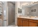 Bathroom with dual sinks, granite countertop, and shower with glass door at 479 Harbor Winds Ct, Winter Springs, FL 32708