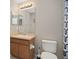 Bathroom featuring a single vanity, a mirror, and a toilet with a patterned shower curtain at 479 Harbor Winds Ct, Winter Springs, FL 32708
