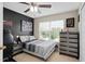Bedroom with modern decor, featuring a large window for natural light and a black accent wall at 479 Harbor Winds Ct, Winter Springs, FL 32708