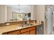 Kitchen view showcases granite countertops, a stainless steel sink, and a glimpse into the living area at 479 Harbor Winds Ct, Winter Springs, FL 32708