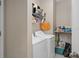 Functional laundry room with modern washer and dryer, shelving for storage, and efficient layout at 479 Harbor Winds Ct, Winter Springs, FL 32708