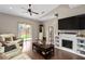 Bright living room featuring a ceiling fan, fireplace, and sliding glass doors to the backyard at 479 Harbor Winds Ct, Winter Springs, FL 32708