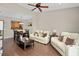 Cozy living room with hardwood floors seamlessly connects to the kitchen and dining area at 479 Harbor Winds Ct, Winter Springs, FL 32708