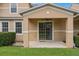 Back patio featuring a ceiling fan, sliding glass doors, and a view of the green, landscaped yard at 479 Harbor Winds Ct, Winter Springs, FL 32708