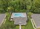 Aerial shot showcases community pool with lounge chairs surrounded by palm trees and green landscaping at 479 Harbor Winds Ct, Winter Springs, FL 32708