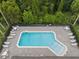 Aerial view of the community pool with surrounding lounge chairs and lush landscaping at 479 Harbor Winds Ct, Winter Springs, FL 32708