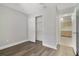 Bedroom features wood-look flooring and sliding closet doors at 4870 S Semoran Blvd # 1905, Orlando, FL 32822