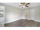 A spacious bedroom features wood-look flooring and a ceiling fan at 4870 S Semoran Blvd # 1905, Orlando, FL 32822