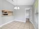 Cozy dining area with chandelier lighting and a convenient pass-through to the kitchen at 4870 S Semoran Blvd # 1905, Orlando, FL 32822