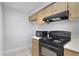 Efficient kitchen layout with black appliances, wooden cabinets, and lots of countertop space at 4870 S Semoran Blvd # 1905, Orlando, FL 32822