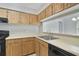 Well-organized kitchen featuring wooden cabinets, ample counter space, and modern appliances at 4870 S Semoran Blvd # 1905, Orlando, FL 32822