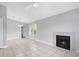 Spacious living area with fireplace, tile floors, and ceiling fan, perfect for relaxation at 4870 S Semoran Blvd # 1905, Orlando, FL 32822