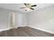 Serene primary bedroom with wood-look floors, ceiling fan, and convenient bathroom and closet access at 4870 S Semoran Blvd # 1905, Orlando, FL 32822
