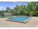 Community pool is surrounded by mature landscaping and lounge chairs at 4870 S Semoran Blvd # 1905, Orlando, FL 32822