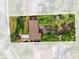 Aerial view of a home with a large lot showcasing mature trees and a well-maintained lawn at 512 Dixson St, Orange City, FL 32763