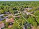 Aerial view of home nestled amongst mature trees on a generous lot surrounded by a lush landscape at 512 Dixson St, Orange City, FL 32763
