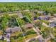 Aerial view of a house with lot lines displayed, showing its boundaries within a neighborhood at 512 Dixson St, Orange City, FL 32763