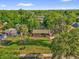 Aerial view of a cozy home surrounded by lush greenery, providing a serene and private setting at 512 Dixson St, Orange City, FL 32763