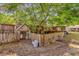Fenced backyard featuring a charming chicken coop, providing a rustic touch to this outdoor space at 512 Dixson St, Orange City, FL 32763