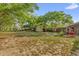 Expansive backyard featuring mature trees and a storage shed, perfect for outdoor activities and relaxation at 512 Dixson St, Orange City, FL 32763