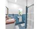 Blue tiled bathroom with a walk-in shower and vintage-style sink at 512 Dixson St, Orange City, FL 32763