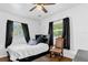 Cozy bedroom with hardwood floors, ceiling fan, and natural light at 512 Dixson St, Orange City, FL 32763