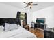 Bedroom featuring a ceiling fan, wood floors, and a built-in headboard shelf at 512 Dixson St, Orange City, FL 32763