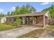 Charming single-story home with covered porch, mature landscaping, and a concrete driveway at 512 Dixson St, Orange City, FL 32763