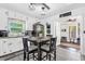 Bright kitchen with a dining area, stainless steel refrigerator, and view to outdoor living at 512 Dixson St, Orange City, FL 32763