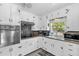 Updated kitchen with white cabinetry and stainless steel oven and microwave at 512 Dixson St, Orange City, FL 32763