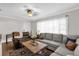 Bright living room with an oversized sectional sofa, patterned rug, and decorative lamps at 512 Dixson St, Orange City, FL 32763
