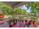 Outdoor patio with colorful decor and furniture and views of the backyard at 512 Dixson St, Orange City, FL 32763