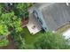 Inviting backyard oasis featuring a fire pit, artificial grass, and mature landscaping at 5165 Mystic Point Ct, Orlando, FL 32812