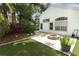 This backyard features beautiful hardscape with synthetic grass and a stone fire pit at 5165 Mystic Point Ct, Orlando, FL 32812