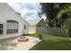 Backyard view of the home featuring hardscape with a fire pit and synthetic lawn at 5165 Mystic Point Ct, Orlando, FL 32812