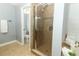 The bathroom features a glass-enclosed shower and neutral finishes at 5165 Mystic Point Ct, Orlando, FL 32812