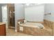 Bright bathroom with a large soaking tub and glass-enclosed shower at 5165 Mystic Point Ct, Orlando, FL 32812