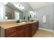 Bright bathroom featuring dual sinks, granite countertops, and tile floors at 5165 Mystic Point Ct, Orlando, FL 32812